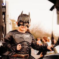 child in batman costume at a community crime event